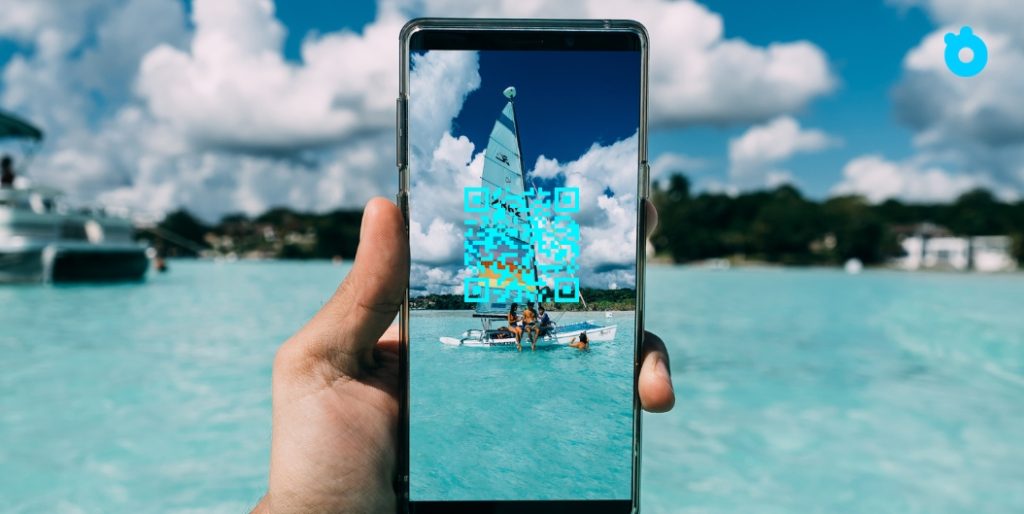 Traveler holding iPhone with eSIM activated abroad